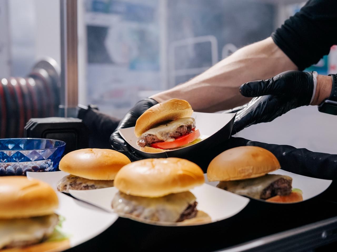 Fresh cheeseburgers being served from the Sizzlin' Street Eats hatch.