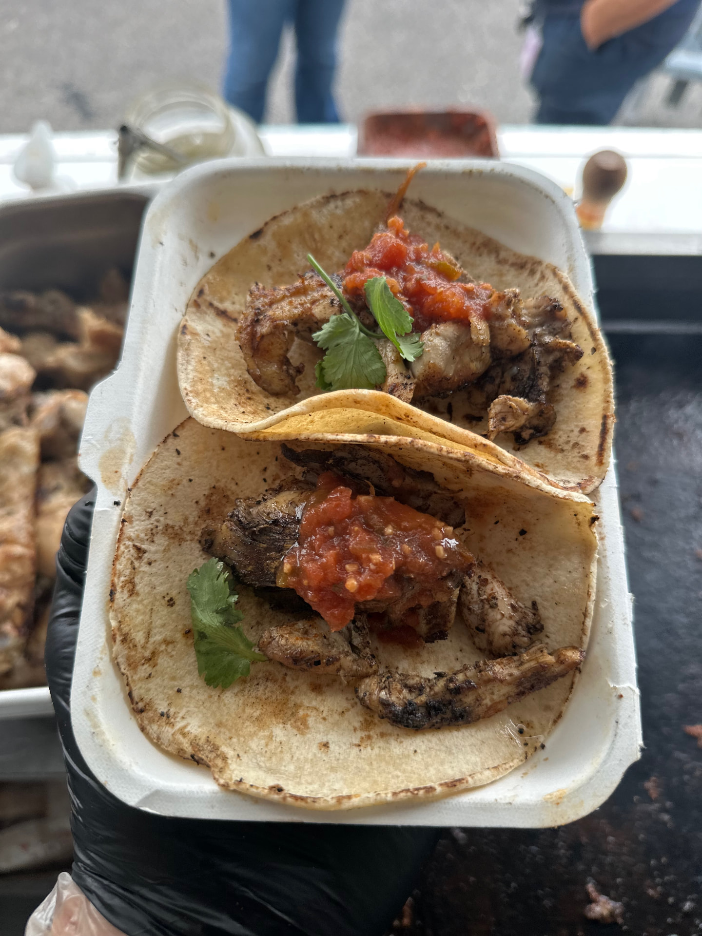 Freshly grilled tacos finished with salsa and coriander.