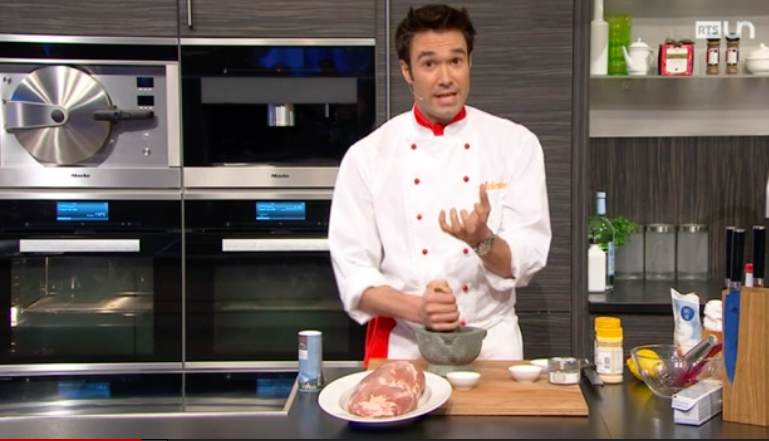 Gregory presenting a dish in the Al Dente studio kitchen.