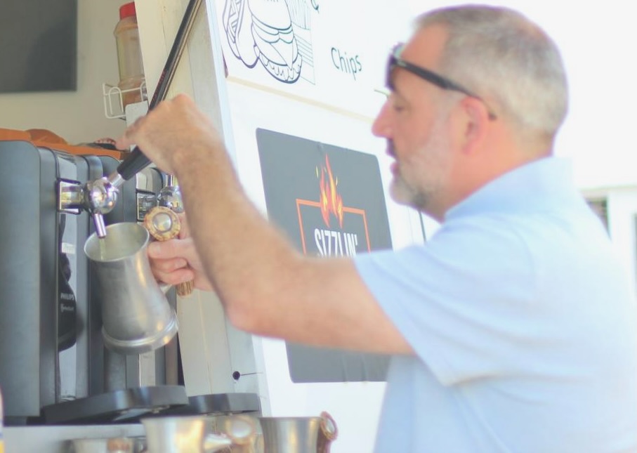 Beer being poured for a Fromage Fiesta guest at the hatch.