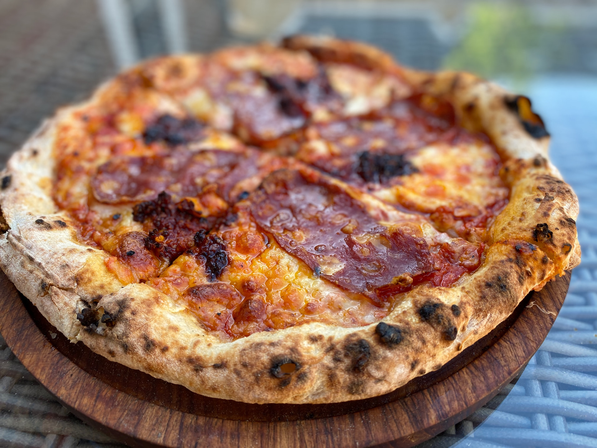 A blistered sourdough pizza with salami and chilli, fresh from the oven.