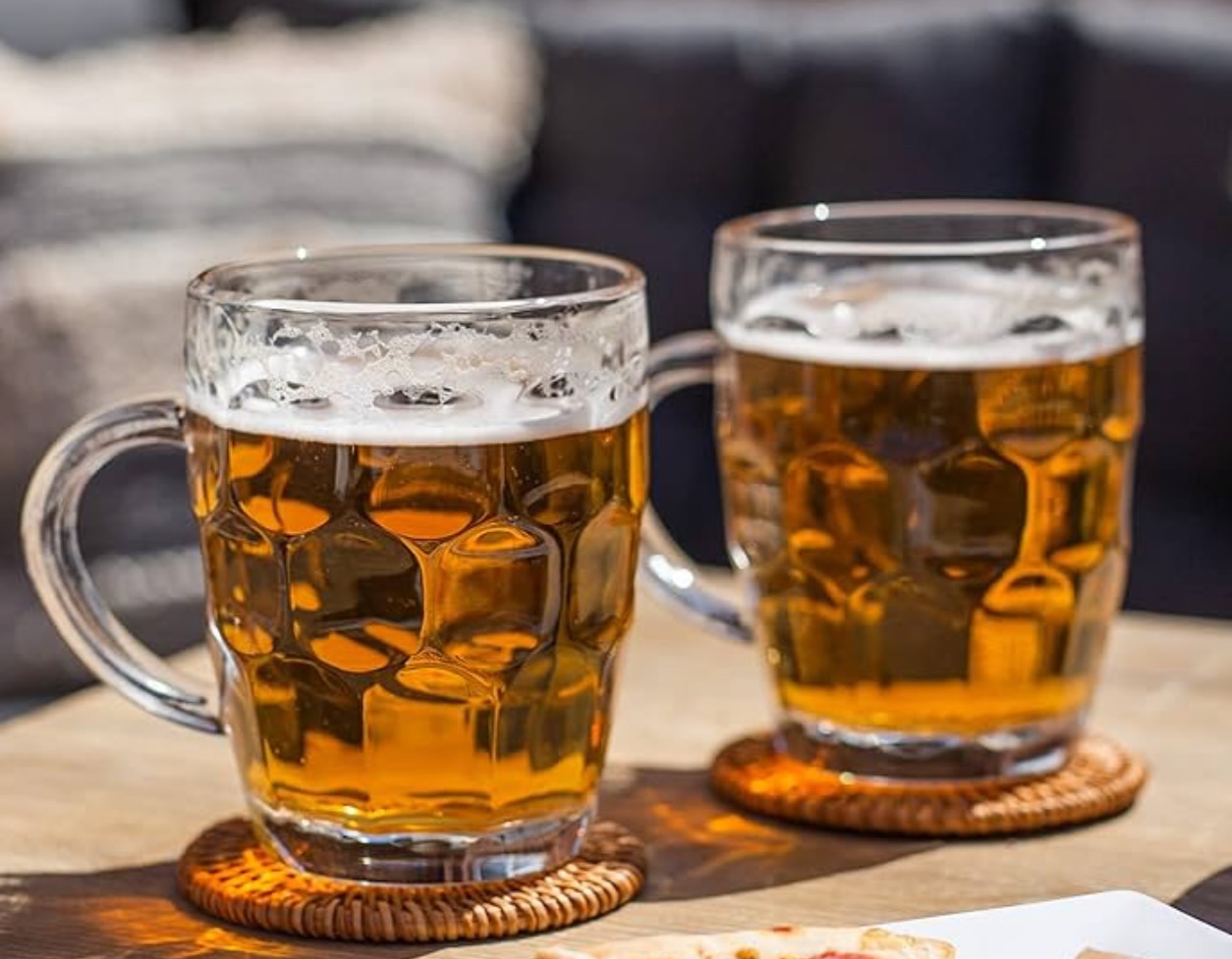 Two glass tankards of beer ready for a Fromage Fiesta gathering.