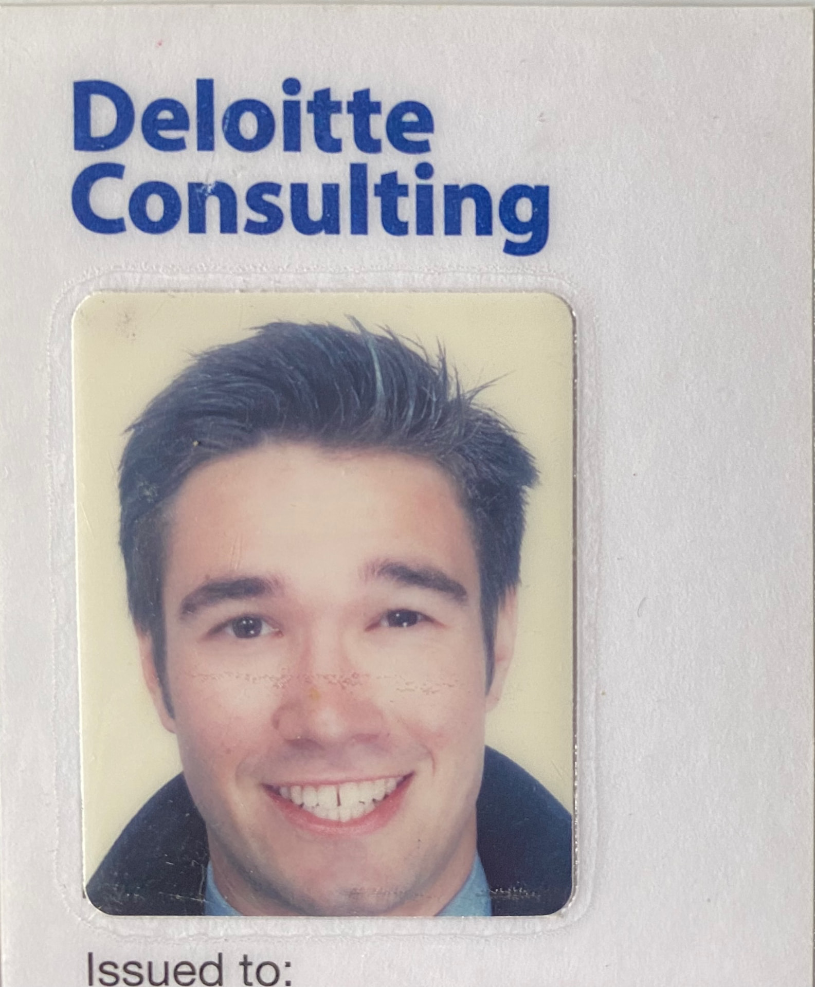 Gregory's Deloitte Consulting staff ID card.