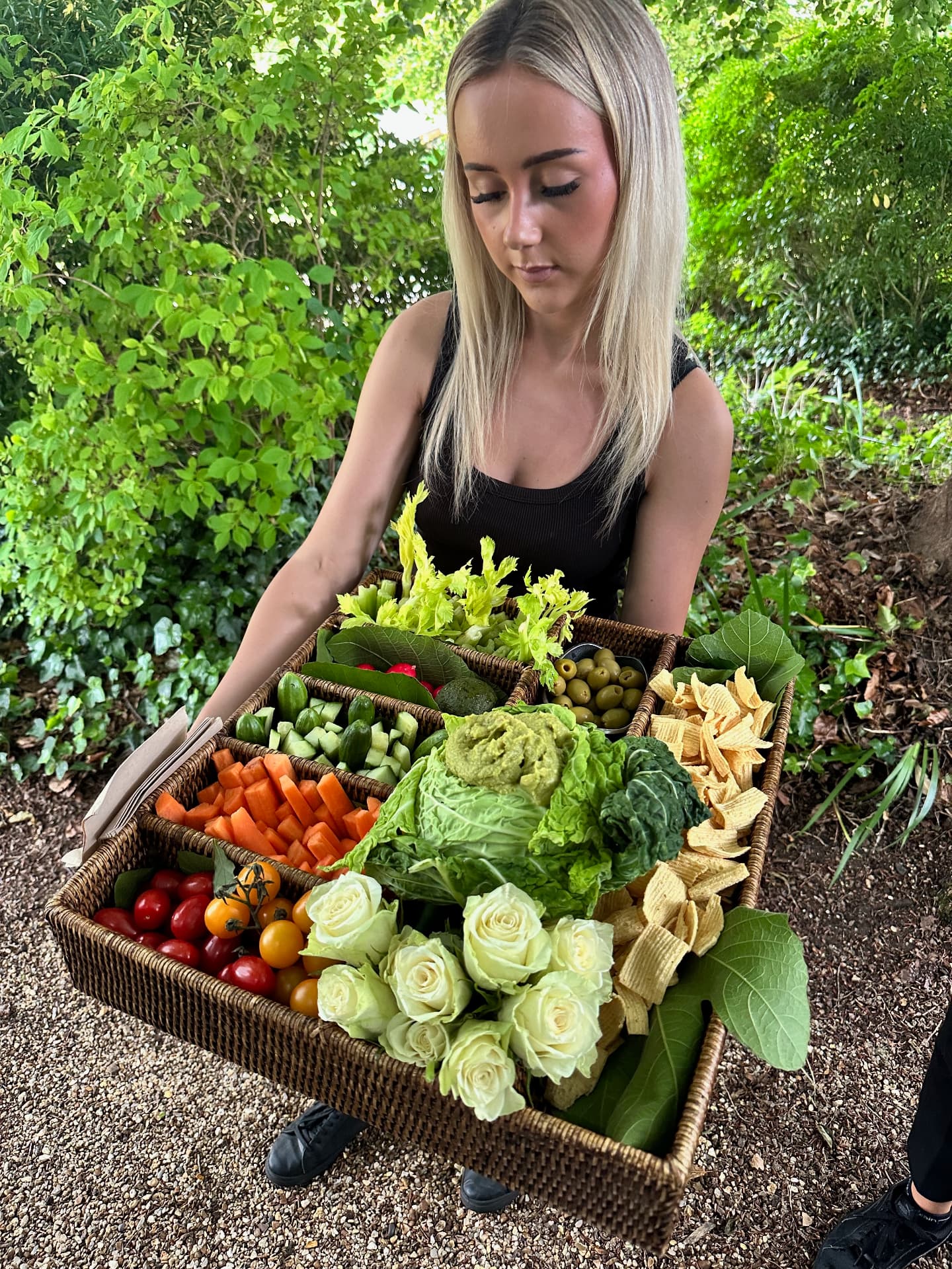 A colourful garden crudité platter being carried to guests.