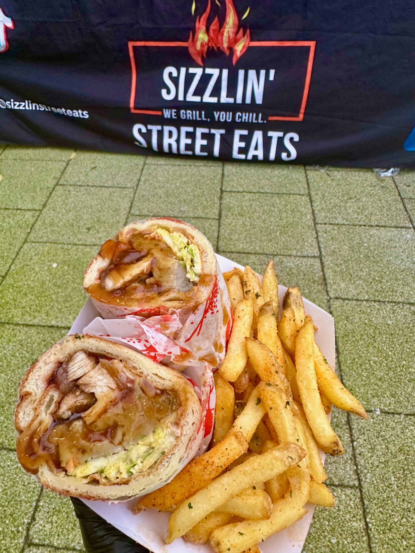 Sizzlin' Street Eats wraps cut open and served with seasoned fries.