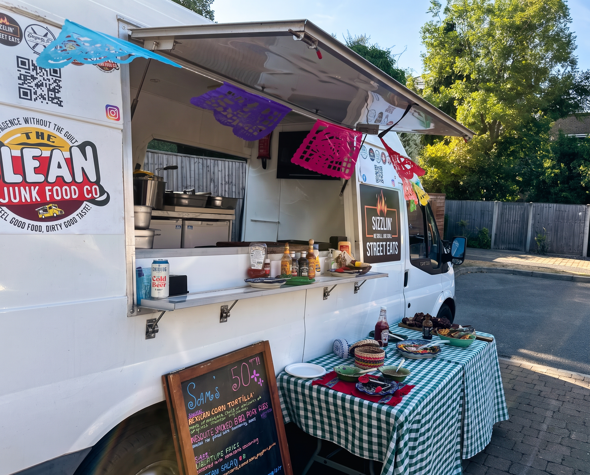 The Clean Junk Food Co. truck with its green checked service table ready for an event.